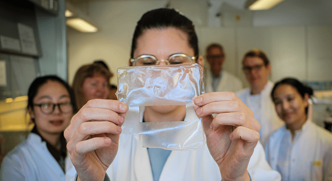 Research team holding plastic wrap